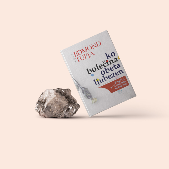 Photograph of a hand holding a smartphone displaying a purple IELTS learning app interface