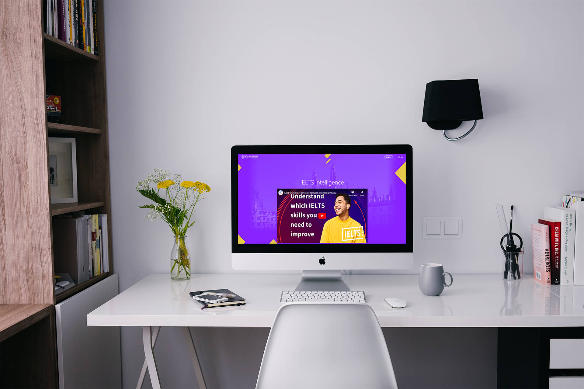 Workspace with laptop displaying IELTS Intelligence platform